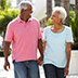 Senior couple walking along the street together.